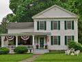 This 1845 Federal features four pilasters topped with Ionic volutes on the facade.