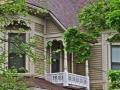 Detail of 2nd story. Note the Eastlake influence in the balustrades and the imbricated fishscale shingles above the clapboard.