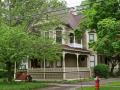 Eastlake Queen Anne built in 1880 with chamfered windows and leaded glass panes.