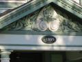 The gable features a floriated palmette set in a bed of leafy branches